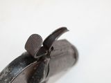 a close up of a gun that is on a white surface
