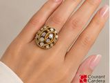 an image of a woman ' s hand with a ring on it ' s finger
