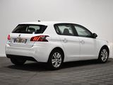 the rear end of a white car parked in a room