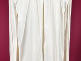 a white shirt on a mannequin stand against a red background
