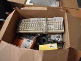 a cardboard box with a keyboard, mouse, and other items in it