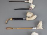several different types of canes are lined up on a gray surface