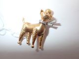 a gold dog with a bow on it ' s neck
