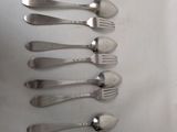 six forks and six spoons arranged in a row