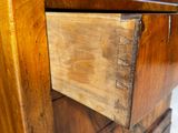 a close up of a wooden dresser with a drawer