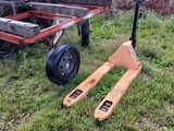 a small wooden cart with a fork next to it