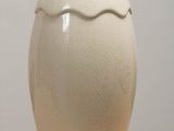 a white vase that is sitting on a table