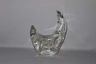 a clear glass vase with a silver design on it