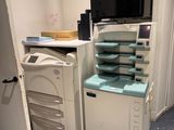 an image of a room with a tv, printer, and cabinets