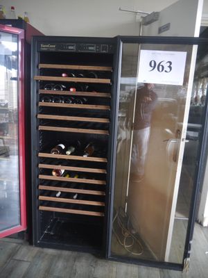 a wine cooler that has many bottles of wine in it