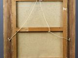 an old wooden easel with a piece of fabric hanging from the top of it