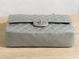 a silver purse sitting on a wooden table