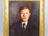 portrait of a young man in a suit and tie in a gold frame