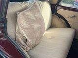 a couch in the back of a car with a pillow on it