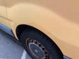 a yellow van that is parked in a parking lot