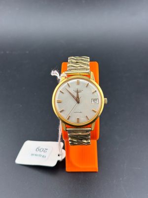 a close up of a wrist watch with a tag on it