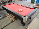 a pool table with balls on it in a warehouse