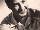black and white photograph of a smiling man in a shirt