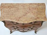 a marble top chest of drawers on display on a white background