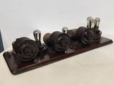 a wooden stand with three different types of valves