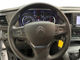 the interior of a car with a steering wheel and dashboard controls