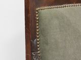 an antique wooden chair with green upholstered upholstered seat