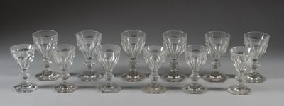 twelve crystal wine glasses lined up in a row