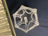 a clear glass object on a blue surface
