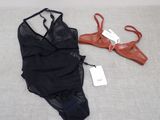 a black bra top and a pair of red shoes on a bed