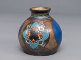 a vase with a design on it on a gray surface
