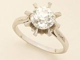 a ring with a diamond on it sitting on a table