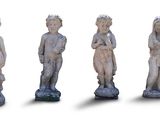 three statues of children are standing in a row on a white surface