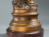 a bronze statue of a man and a dog on a pedestal