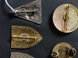 a lot of different types of metal pins on a black surface