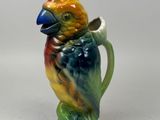 a colorful bird that is sitting on top of a pitcher