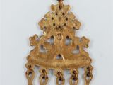 a close up of a gold pendant on a chain