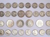 an image of a collection of silver coins on a white surface