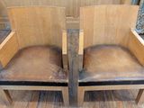 two wooden chairs that are sitting on a hard wood floor