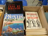 several books are stacked on top of each other in a box