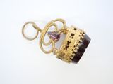 gold and garnett necklace with a purple stone and a gold chain