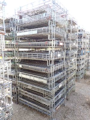 a large pile of metal cages stacked on top of each other