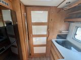 a kitchen with a refrigerator, stove, microwave, and refrigerator