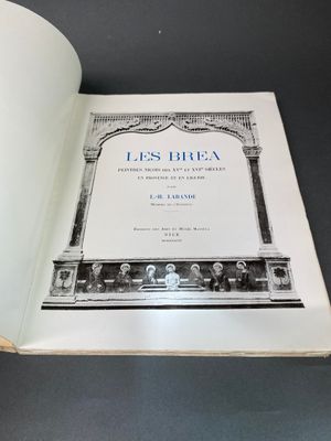 un livre ouvert posé sur une table à côté d'une tasse de café