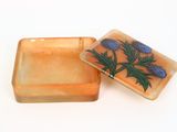 two soap bars with flowers on them on a white surface