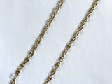 a close up of a gold chain on a white background
