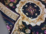 a close up of a scarf with a floral design