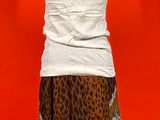 a dress on a mannequin stand with a red background