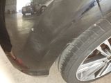 a person standing next to a car in a garage