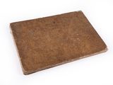 an old book sitting on top of a white table with a white background