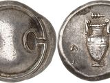 a silver coin with an image of a vase on it